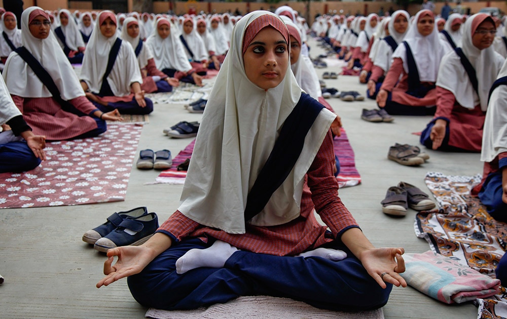 आंतरराष्ट्रीय योगदिन! Muslim students practice yoga at a school ahead of first International Yoga Day in Ahmadabad.
