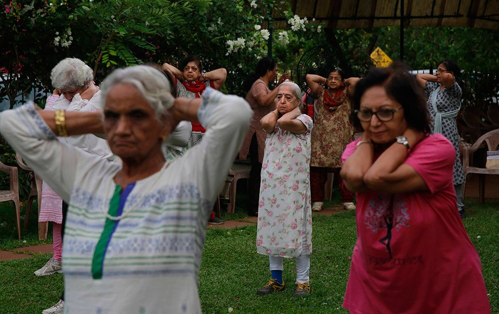 आंतरराष्ट्रीय योगदिन! Elderly people perform early morning yoga in a park in Mumbai.
