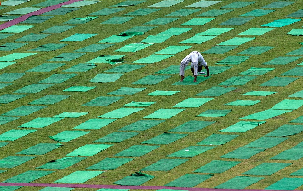 आंतरराष्ट्रीय योगदिन! A man performs yoga in a stadium in New Delhi.
