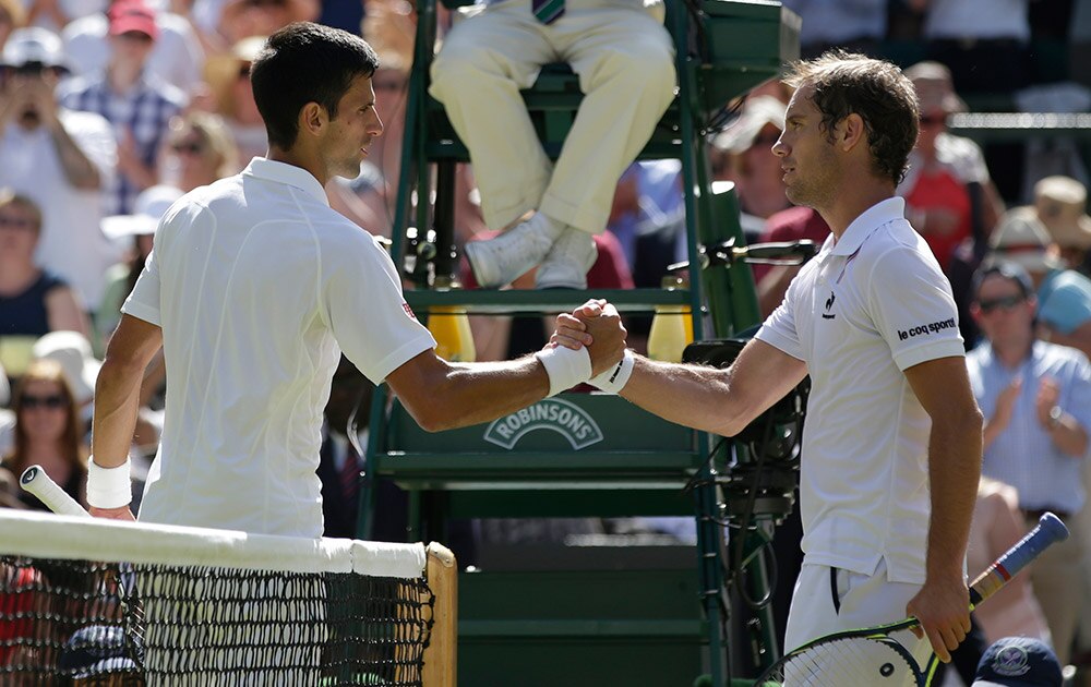 NOVAK DJOKOVIC OF SERBIA SHAKES HANDS AT THE NET WITH RICHARD GASQUET OF FRANCE AFTER WINNING THEIR MEN'S SINGLES SEMIFINAL MATCH
