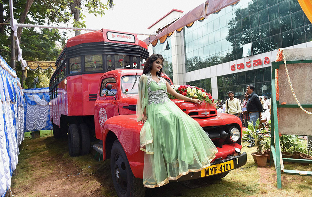 Kannada actress Mayuri poses with an old bus Banshankari which was operated in 1947 in Vijayapura(Bijapur) in northern Karnataka, on display at Karnataka.