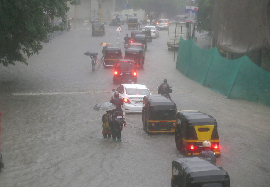 Vehicles plying at a flooded road 