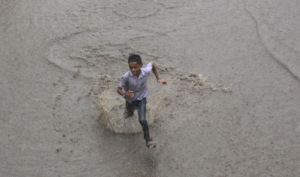 A boy runs through a street