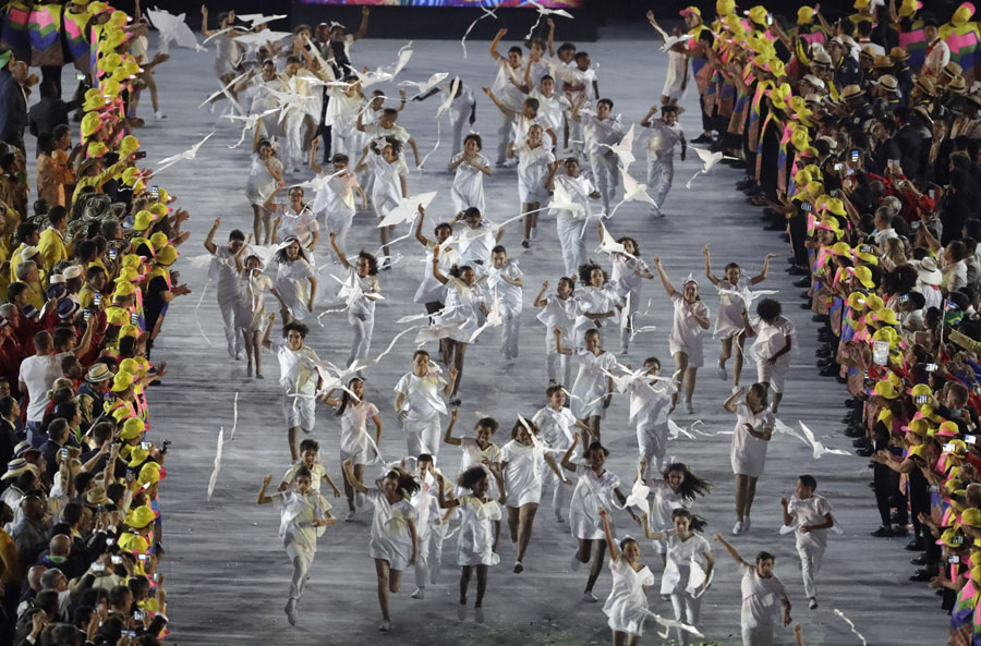 Children run with kites representing the dove of peace 