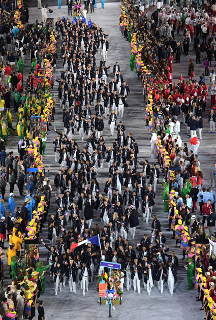 Teddy Riner carries the flag of France