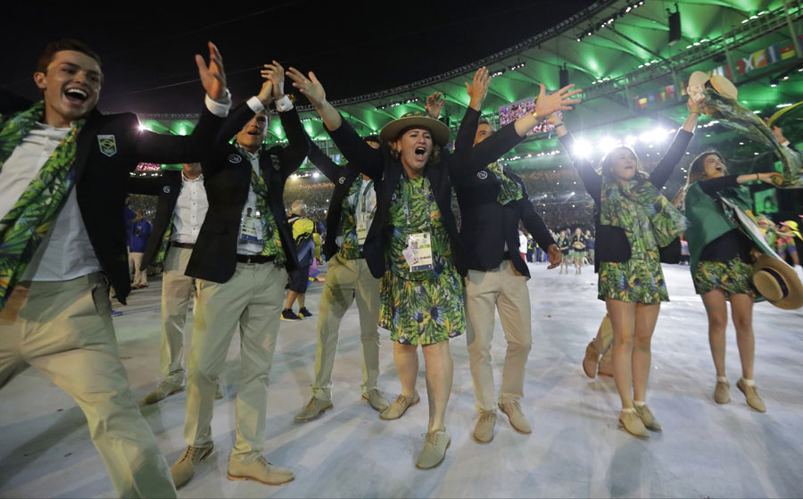 Brazil wave as they walk in the arena