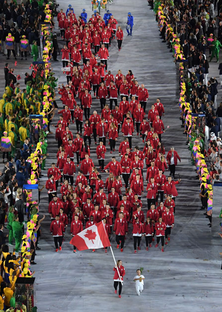 Rosannagh Maclennan carries the flag of Canada