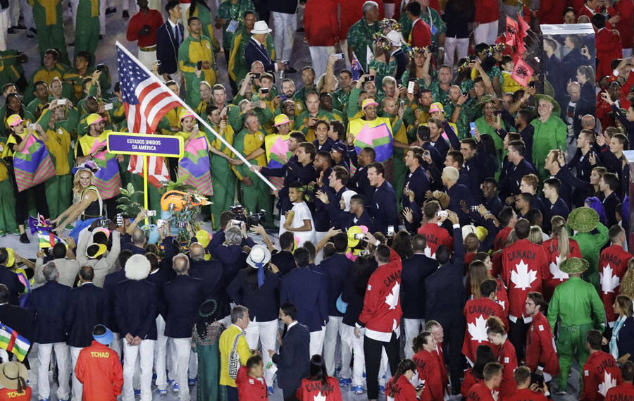 Michael Phelps carries the flag of the United States