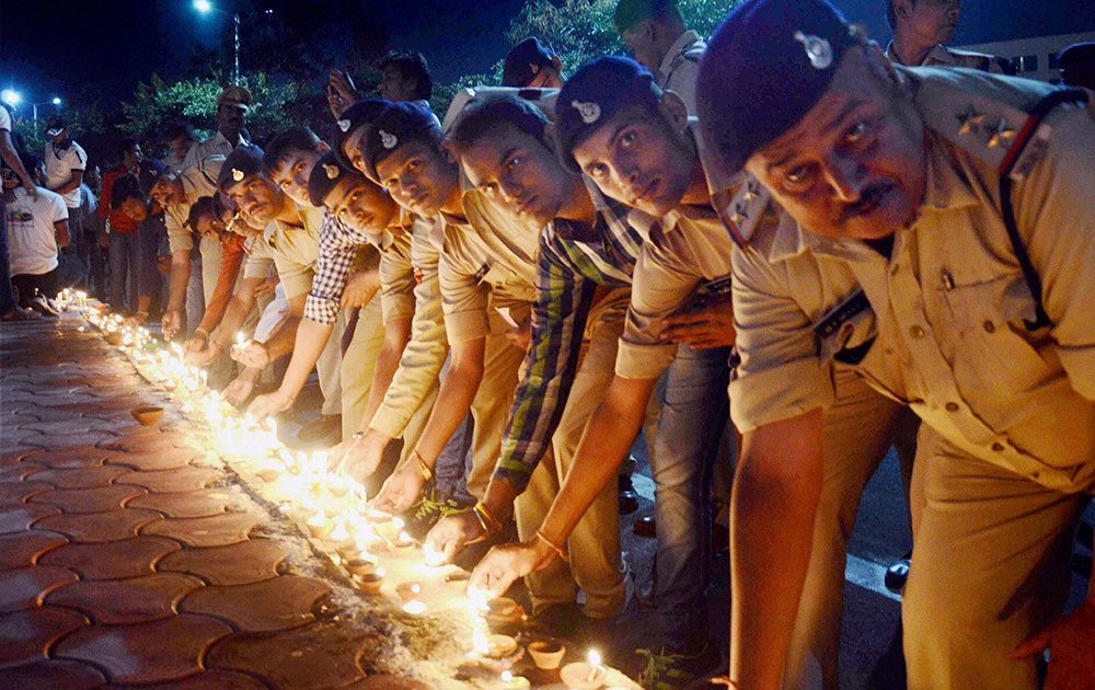 Police personnel lighting lamps in a campaign Ek Diya Shaheedon Ke Naam during a program on the eve of Diwali festival in Bhopal