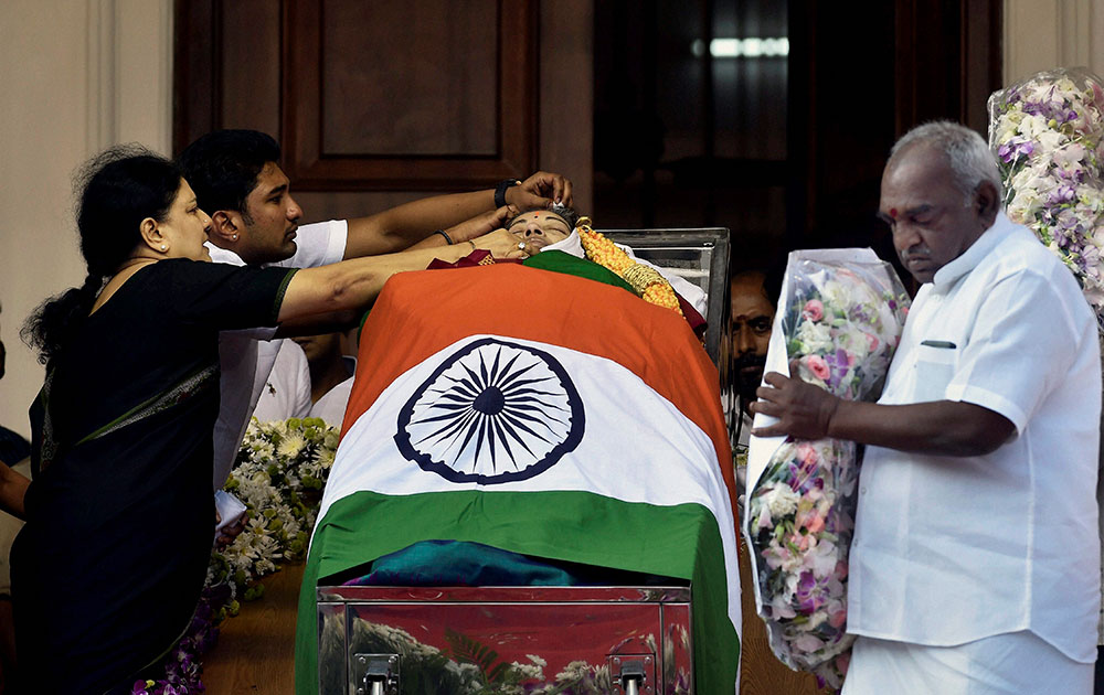 V Sasikala, the close aide of Tamil Nadus former Chief Minister Jayaram Jayalalithaa adjusts a cloth around her mortal remains