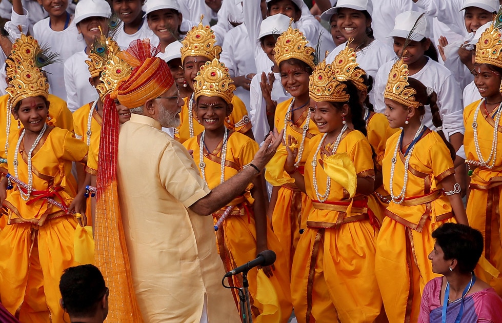 Prime Minister Modi greets school girls dressed as Hindu Lord Krishna