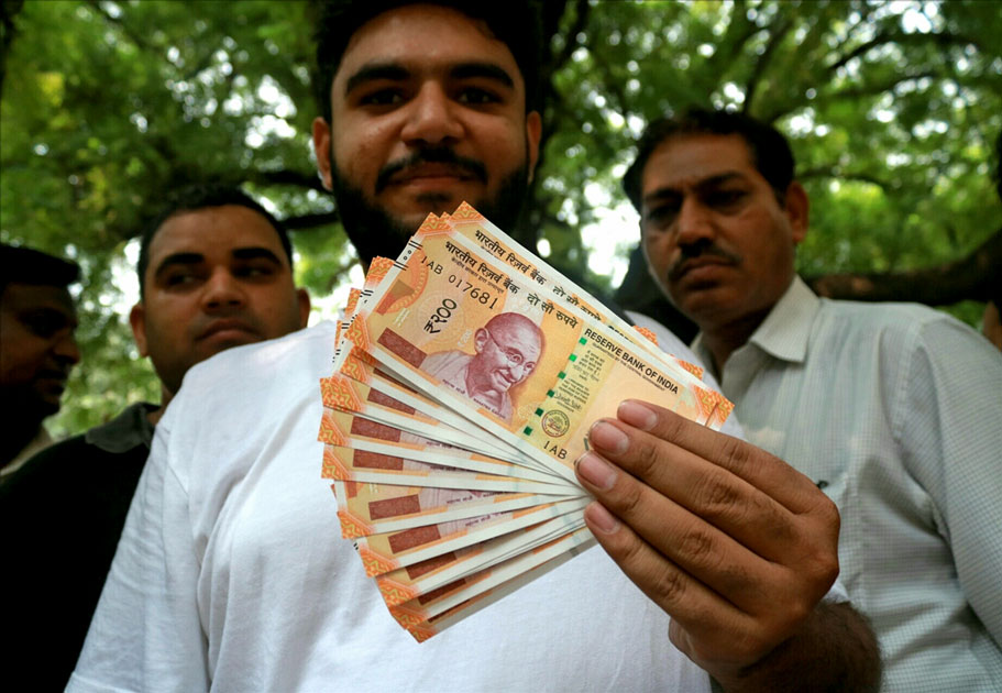 A man shows the new Rs 200 currency note outside Reserve Bank of India