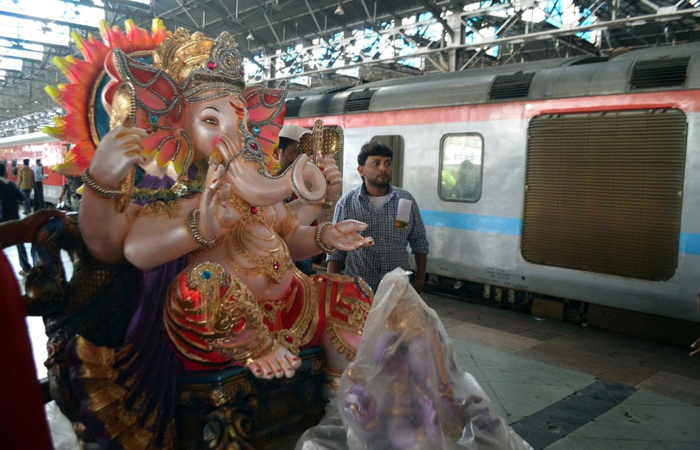 A Ganesha idol is being loaded on a train