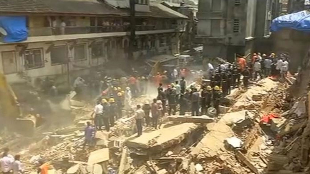 People and rescue personnel are seen after a building collapsed