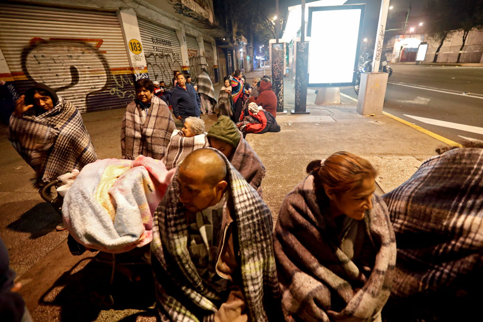 People gather on a street after an earthquake hit Mexico City