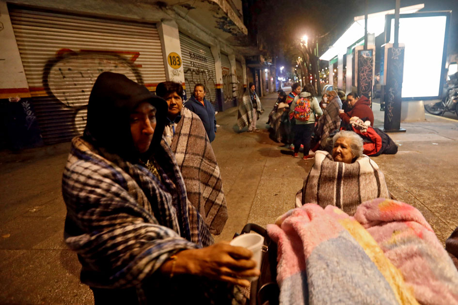 People gather on a street after an earthquake hit Mexico City