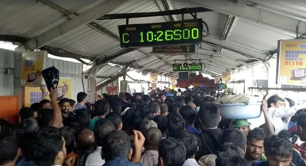 Crowds of commuters move along Elphinstone railway station bridge in Mumbai.