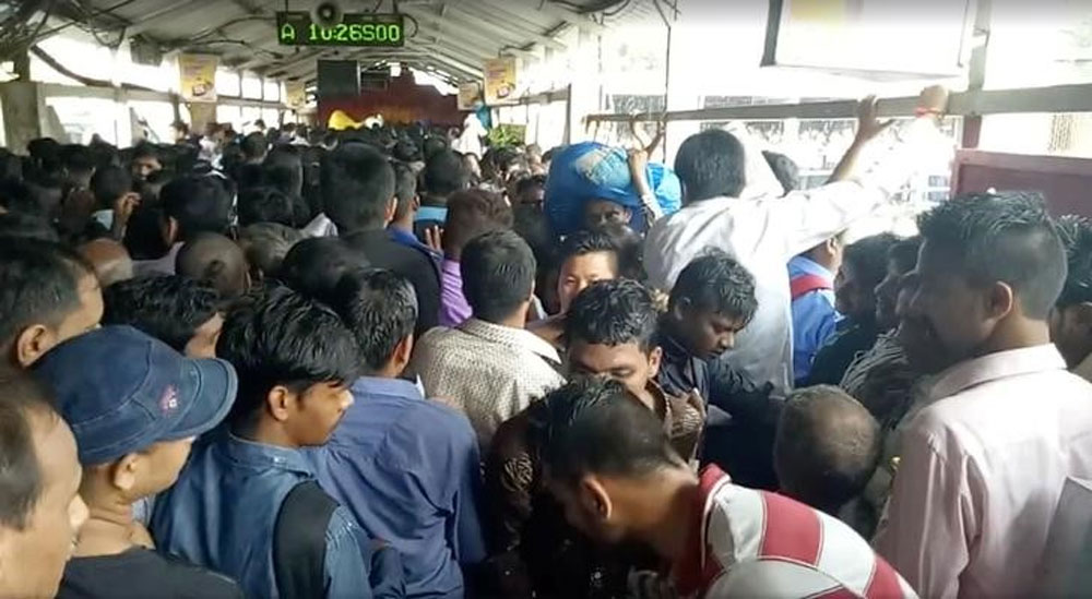 Crowds of commuters move along Elphinstone railway station bridge in Mumbai.