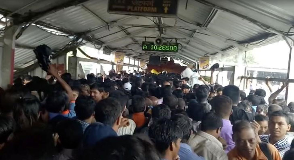 Crowds of commuters move along Elphinstone railway station bridge in Mumbai.