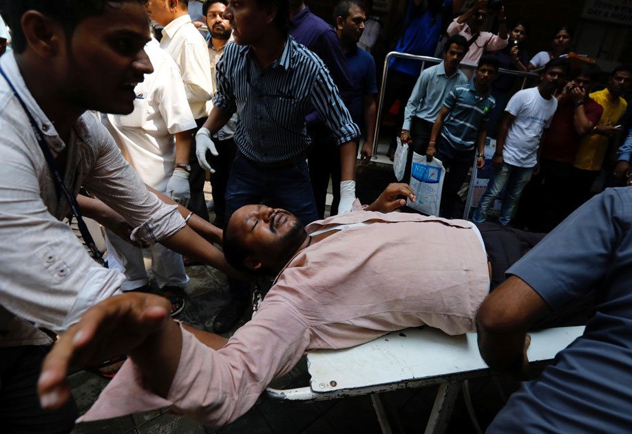 A stampede victim is carried on a stretcher at a hospital in Mumbai.