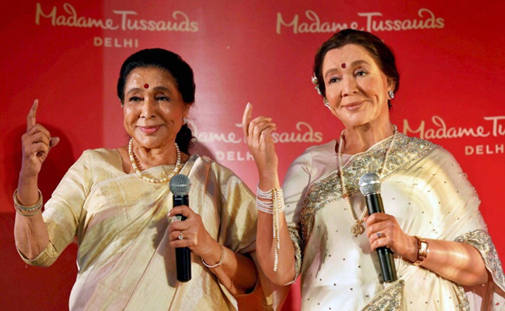 Legendary singer Asha Bhosle poses with her wax-statue during its unveiling, in New Delhi. The statue will be installed at the Madame Tussauds Delhi.