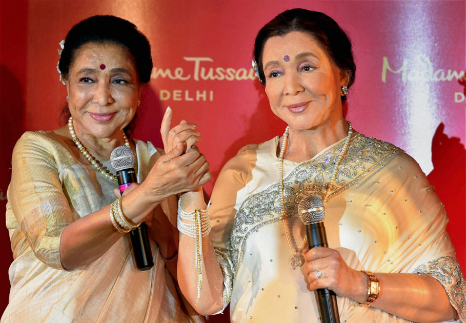 Legendary singer Asha Bhosle poses with her wax-statue during its unveiling, in New Delhi.