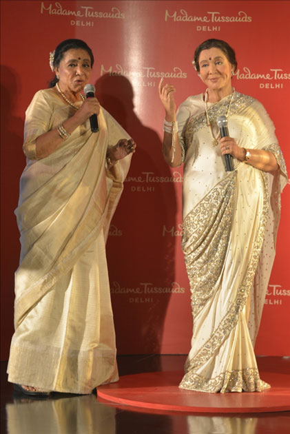 Veteran singer Asha Bhosle with her wax statue that was unveiled at the Madame Tussauds museum in New Delhi.