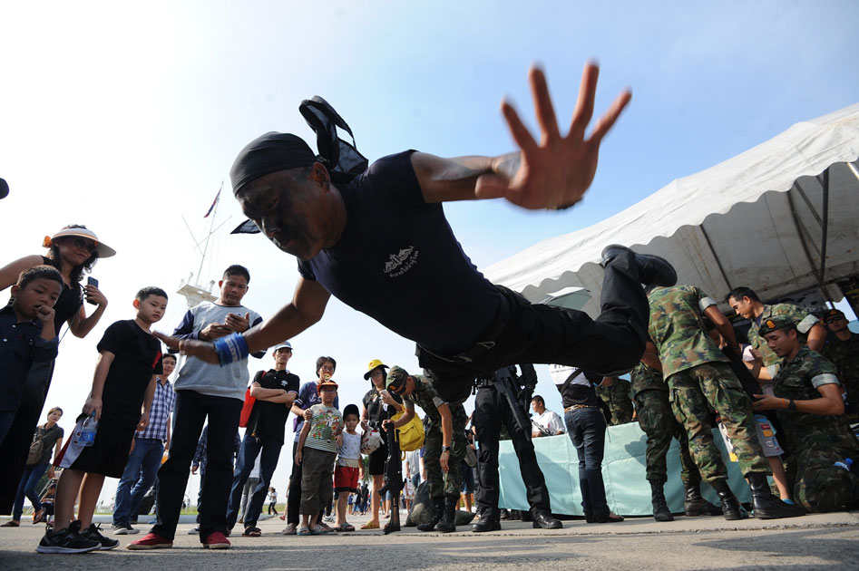 Children and their parents watch a military stunt show during a Children`s Day public-opening event at the Royal Thai Naval Academy in Bangkok, Thailand.