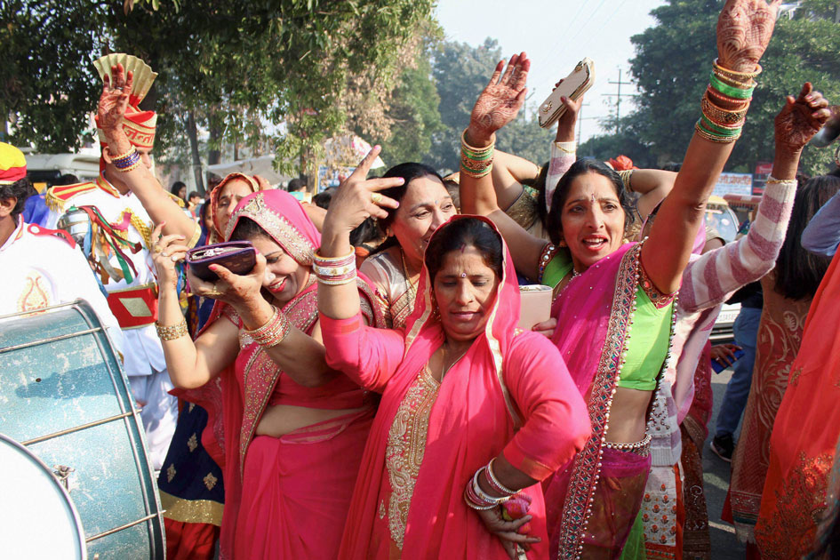 Family members and relatives dance during speedster Bhuvneshwar Kumar`s marriage procession in Meerut.
