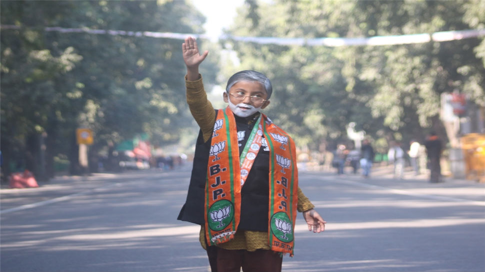 A young boy dressed as PM Narendra Modi is seen at BJP headquarters in New Delhi