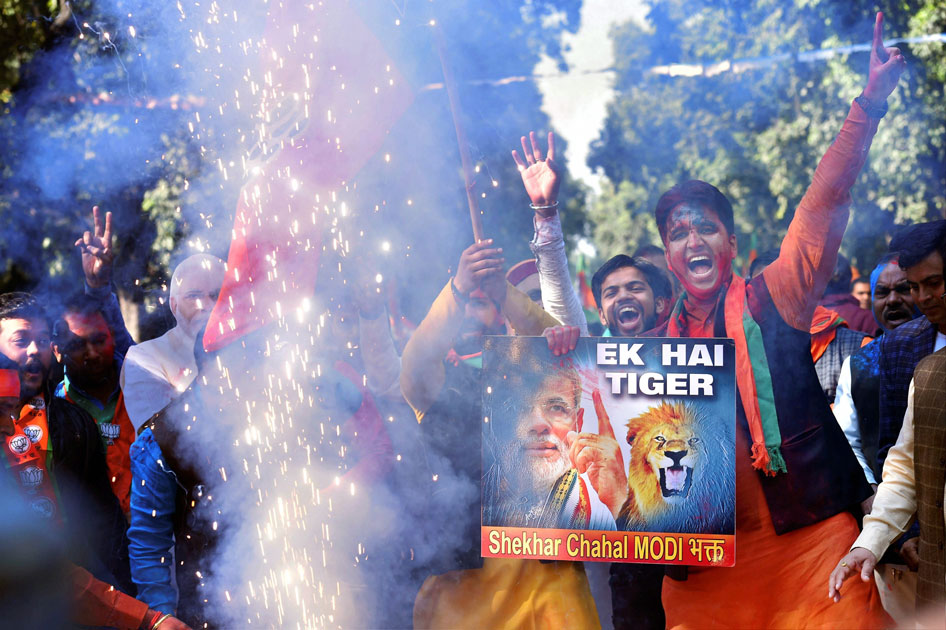 Party workers and supporters celebrating BJP`s success in the state assembly elections outside the BJP headquarter, in New Delhi.