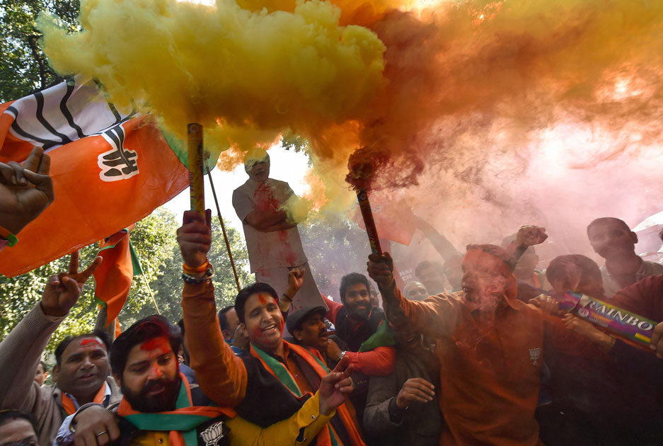 Party workers and supporters celebrating BJP`s success in the Gujarat and Himachal Pradesh state assembly elections, outside the BJP headquarter in New Delhi.