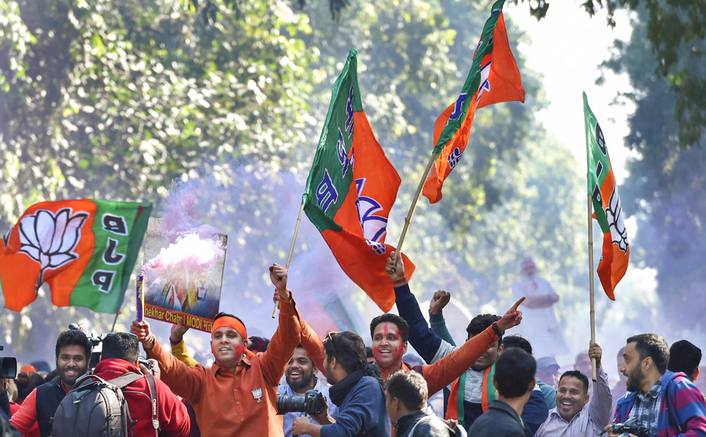 Party workers and supporters celebrating BJP`s success in Gujarat and Himachal Pradesh state assembly elections outside the BJP headquarter, in New Delhi.