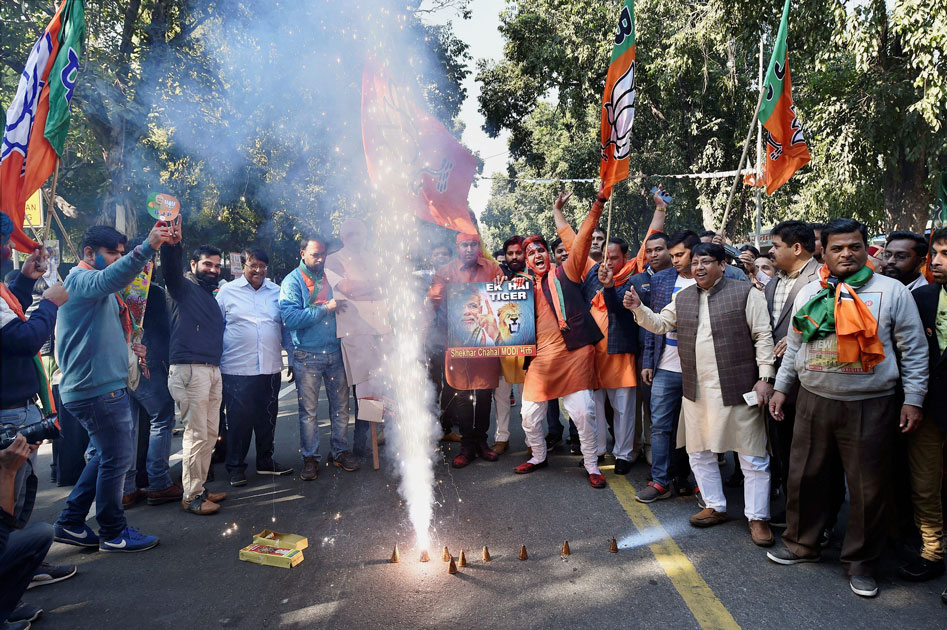 Party workers and supporters celebrating BJP`s success in the state assembly elections outside the BJP headquarter, in New Delhi.