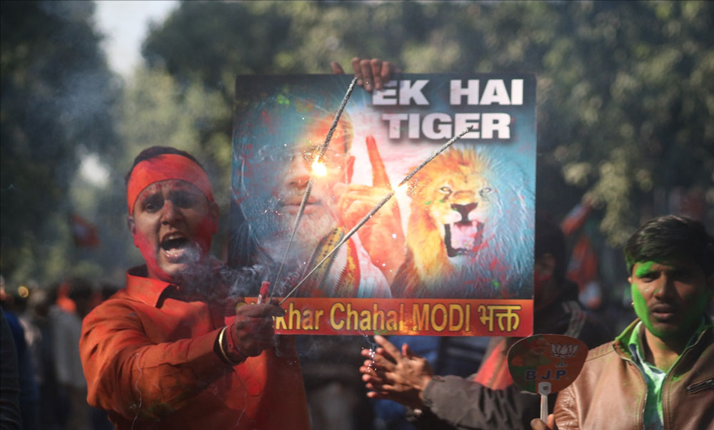 BJP workers celebrate the party`s performance in Himachal Pradesh and Gujarat assembly elections, in New Delhi.