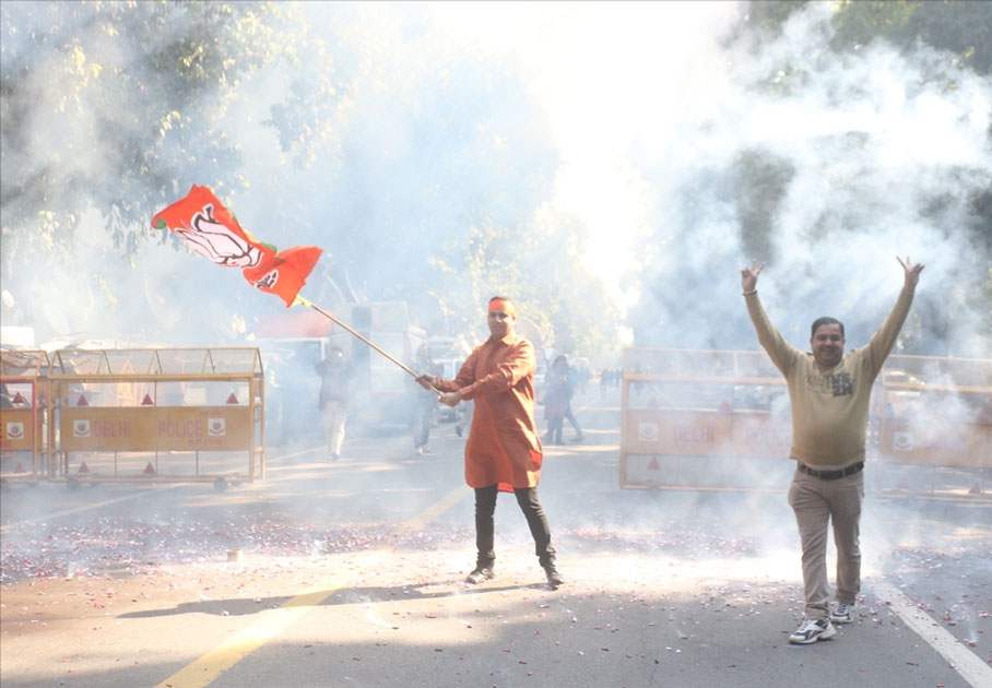 A party worker during celebrations over the party`s performance in Himachal Pradesh and Gujarat assembly elections in New Delhi.