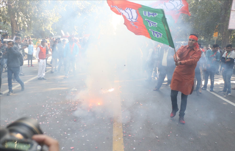 A party worker during celebrations over the party`s performance in Himachal Pradesh and Gujarat assembly elections in New Delhi.