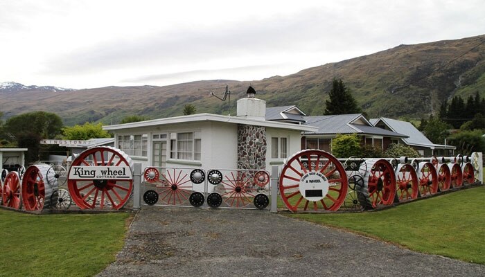 Wheel cottage on the side of Kingston Road. Wheeled fence with wheel.