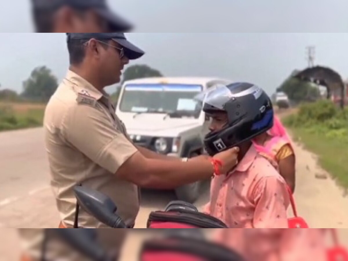 मंत्रोच्चारणासह पोलिसांनी दुचाकीस्वाराला घातलं हेल्मेट, सोशल मीडियावर Video Viral  title=