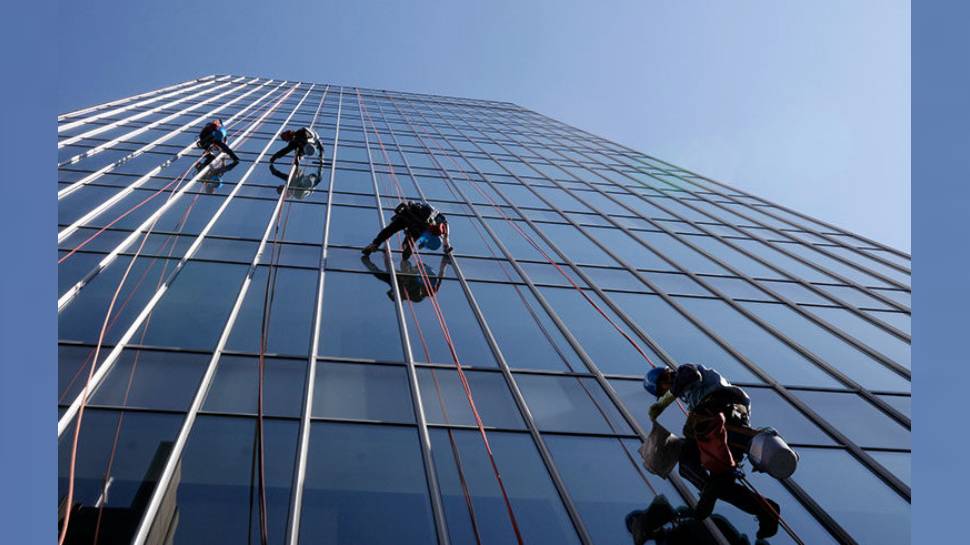 woman cuts ropes of workers working on 32nd floor in hi rise building