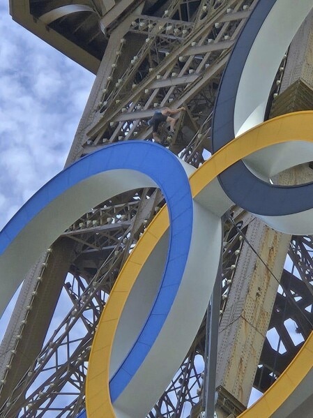 Man Climbing Eiffel Tower