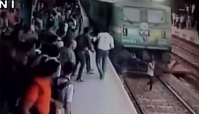 Video : फोनवर बोलत असताना तरूणी आली ट्रेन खाली, पण सुदैवाने वाचली...