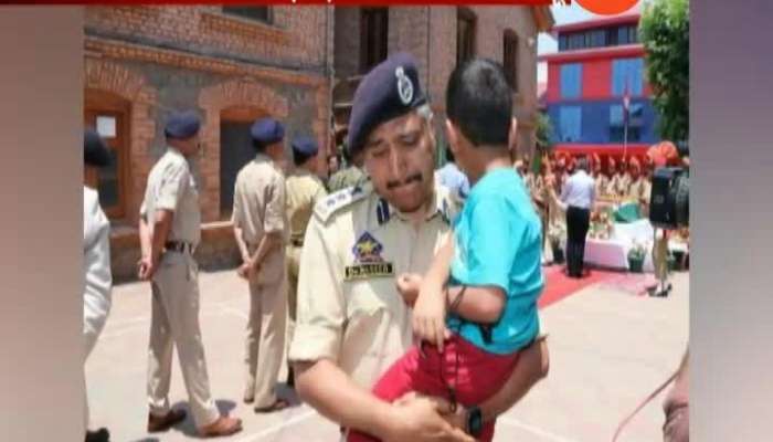 POLICE MAN CARRYING KILLED COP_S 4-OLD SON BREAKS DOWN DURING HOMAGE