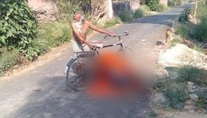 वृद्ध पत्नीचा सायकलीवरुन मृतदेह नेताना खाली कोसळला, फोटो व्हायरल